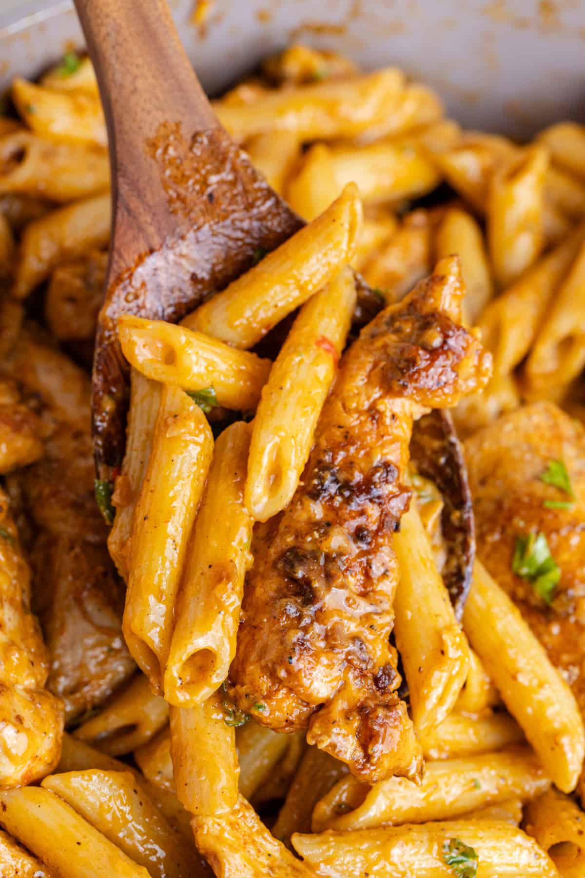 Bang Bang Chicken Pasta up close on a serving spoon in the skillet