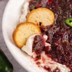 Cranberry Jalapeño Dip with crackers in a bowl close up