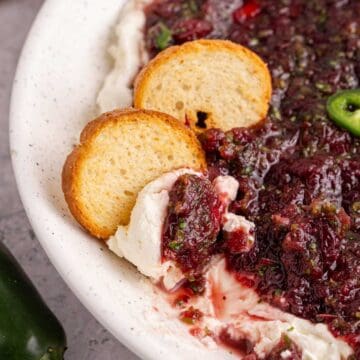 Cranberry Jalapeño Dip with crackers in a bowl close up