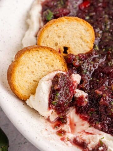 Cranberry Jalapeño Dip with crackers in a bowl close up