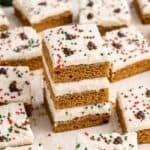 Gingerbread Cookies Bars with Icing and sprinkles on parchment paper stacked