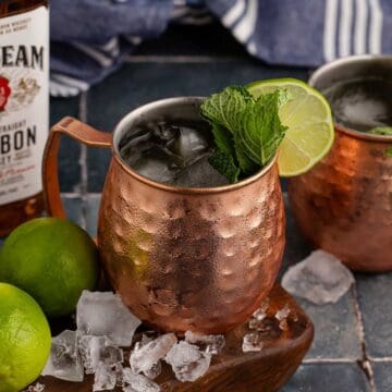 Kentucky Mule Cocktail on a serving board with ice all around