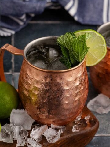 Kentucky Mule Cocktail on a serving board with ice all around