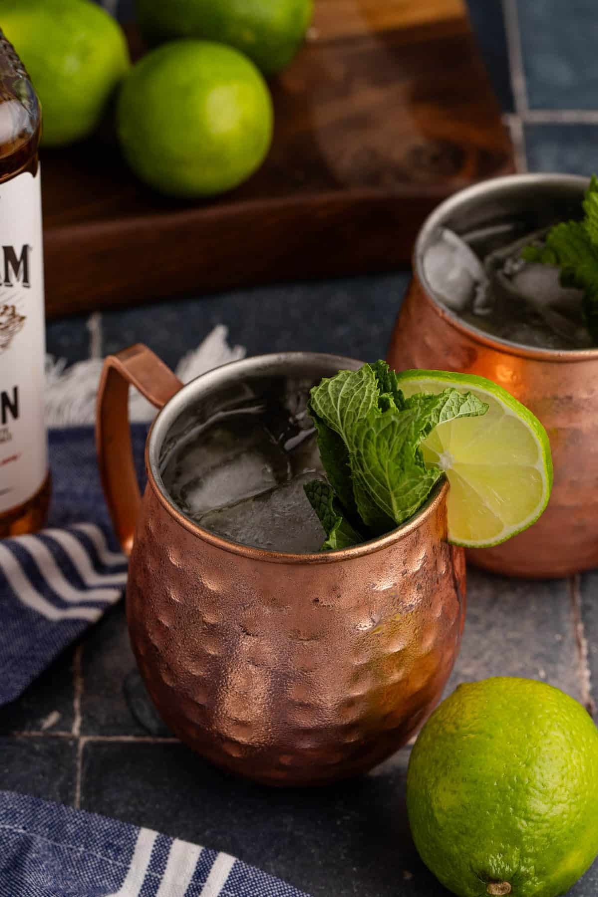 Kentucky Mule Cocktail with limes in the back and beside