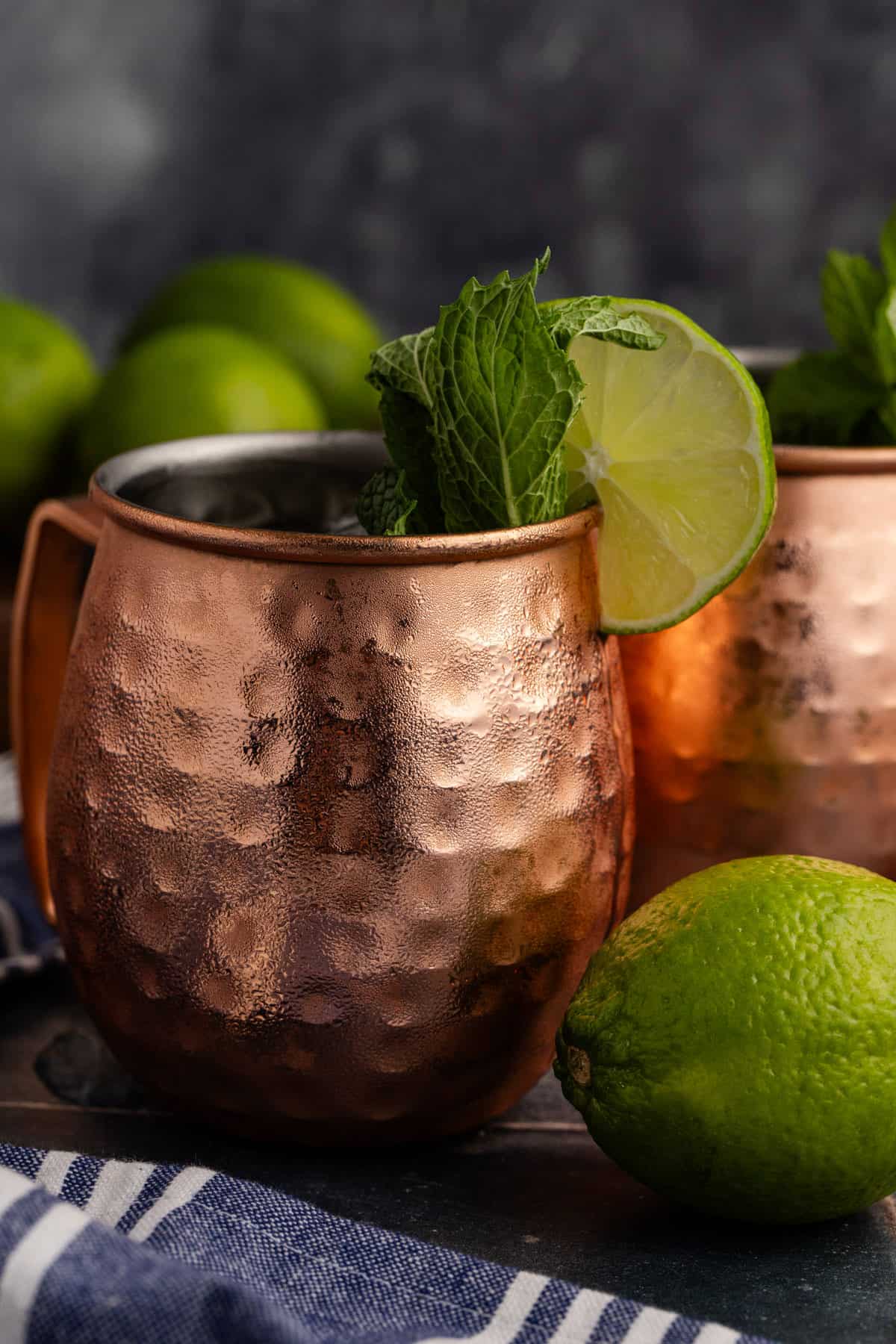 Kentucky Mule Cocktail in a Moscow Mule mug with a lime round and mint garnish