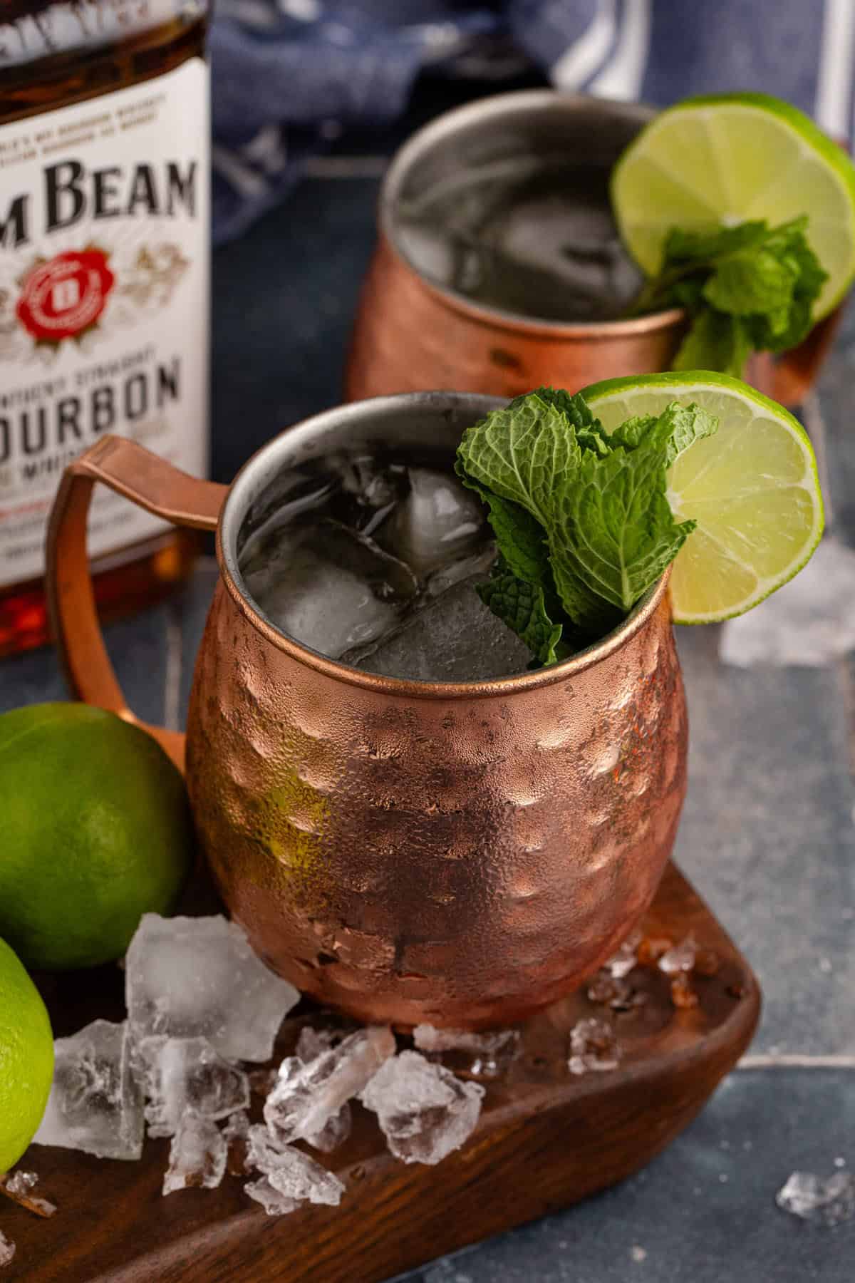 Kentucky Mule Cocktail on a serving board with ice all around