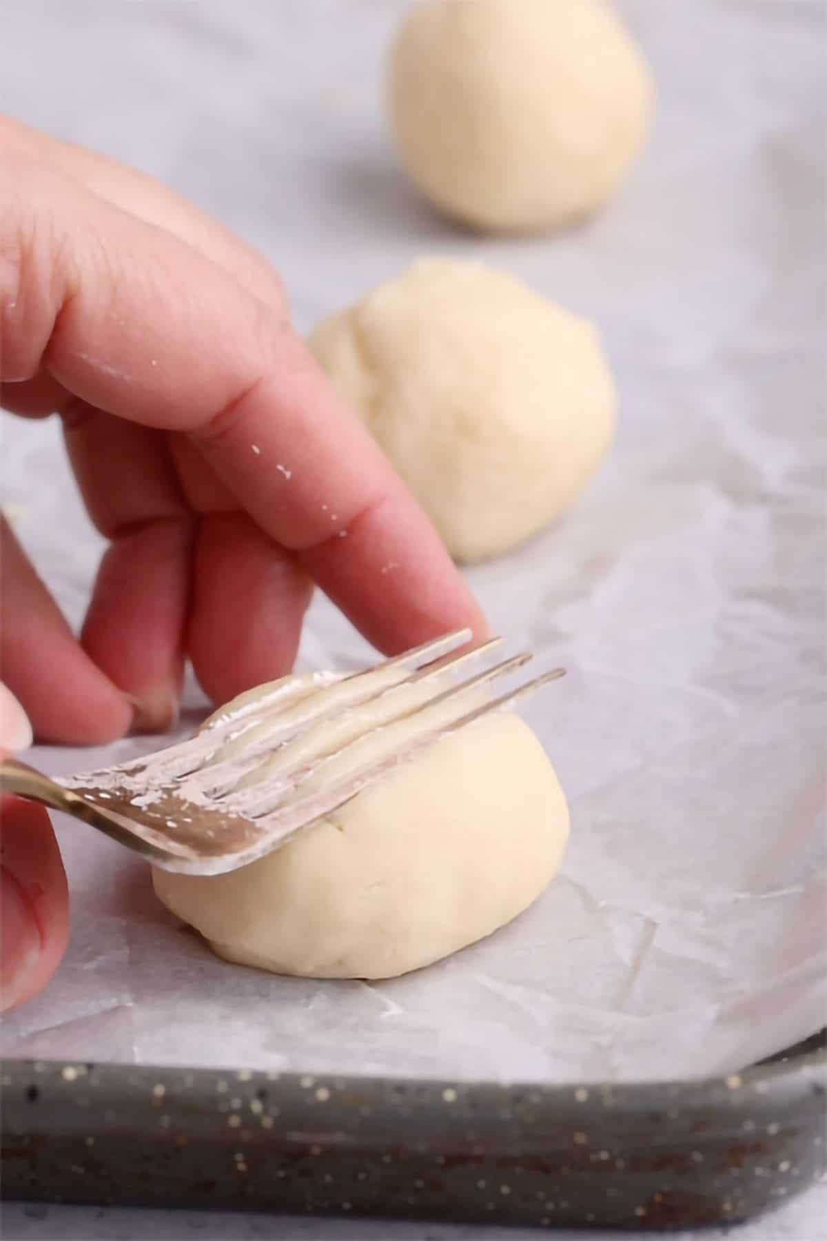 Whipped Shortbread Cookie being made on a baking sheet with parchment paper